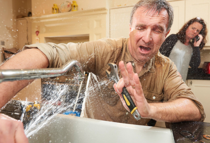 Man trying to fix sink doing his own plumbing work