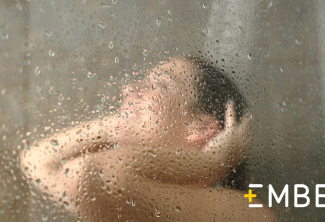 Woman showering in warm hot water